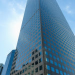 Picture of a very tall building in the Denver downtown area. It's very blocky and completely covered in identical windows.