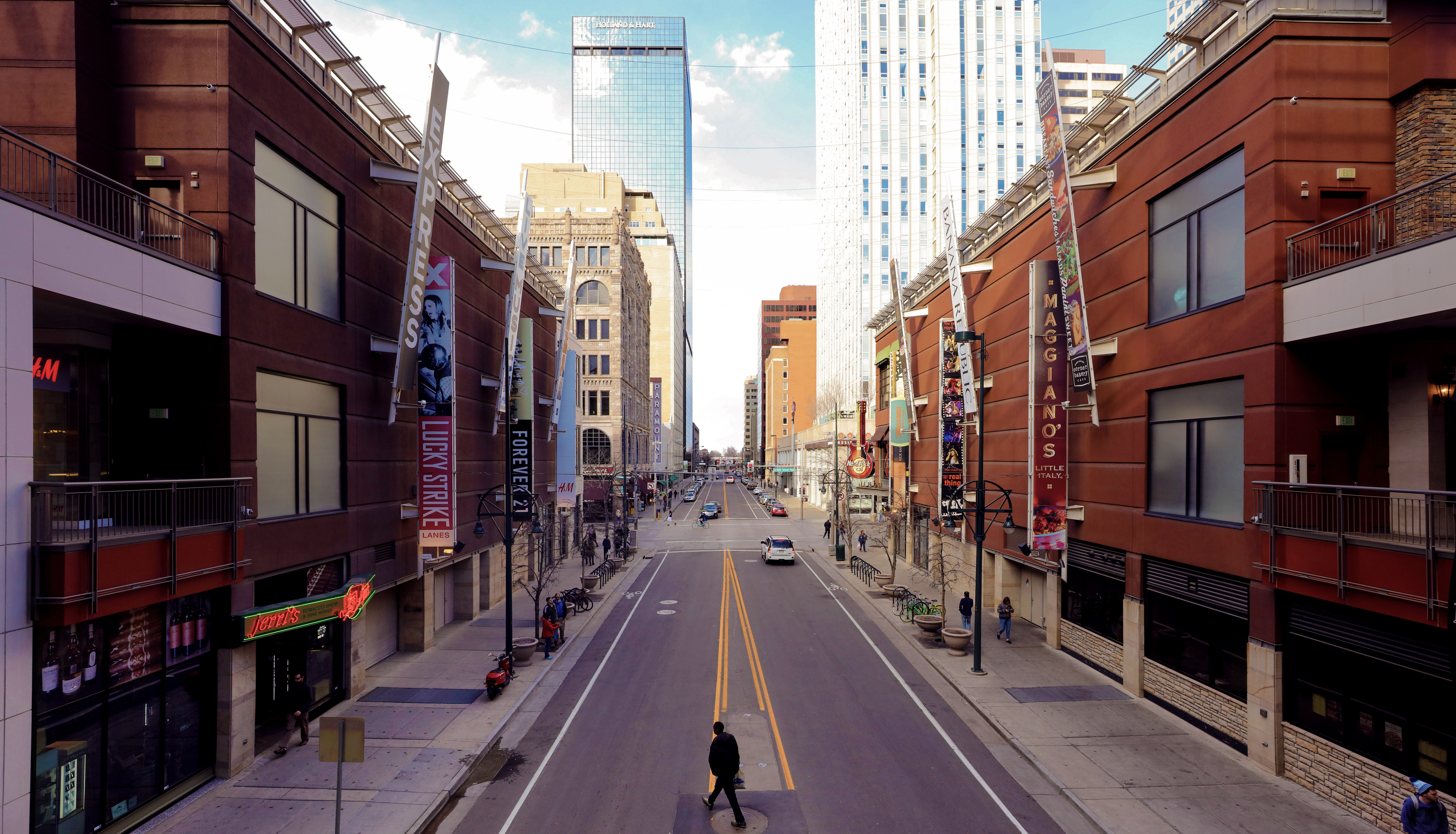 A picture of downtown Denver with buildings lining both the left and right sides of the street