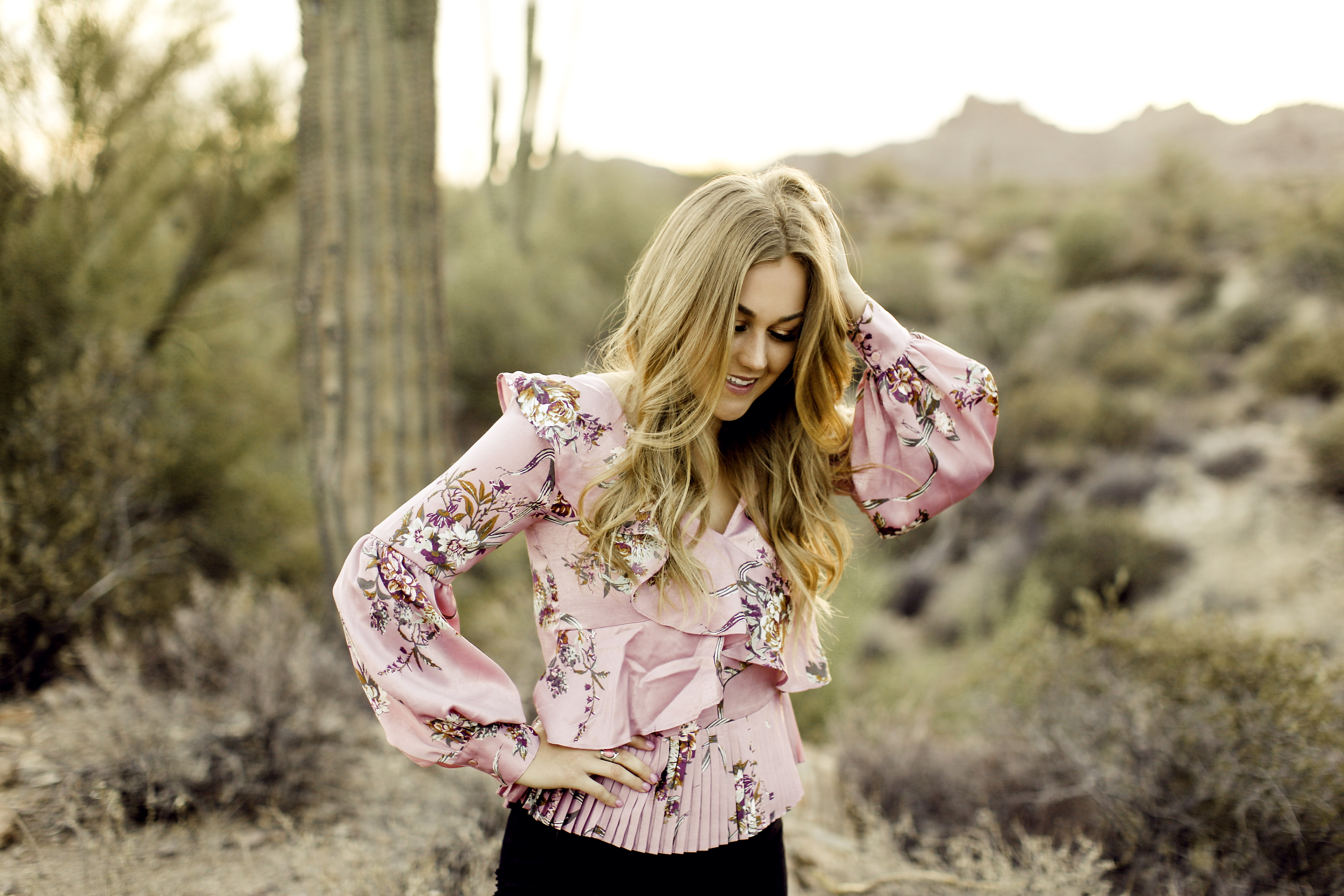 High school senior posing for photos at Lost Dutchman National Park in the morning.