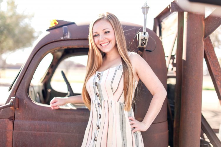 Portrait at Tumbleweed Park in front of an old, broken down work truck